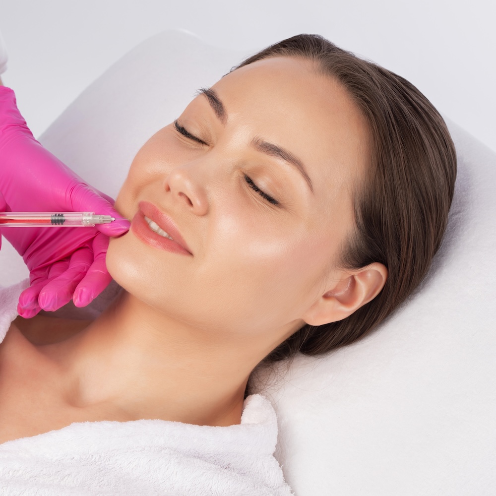 Woman receiving a lip filler treatment