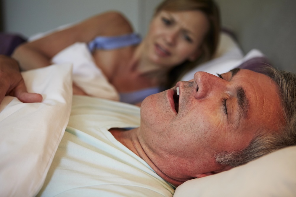husband snoring next to his wife